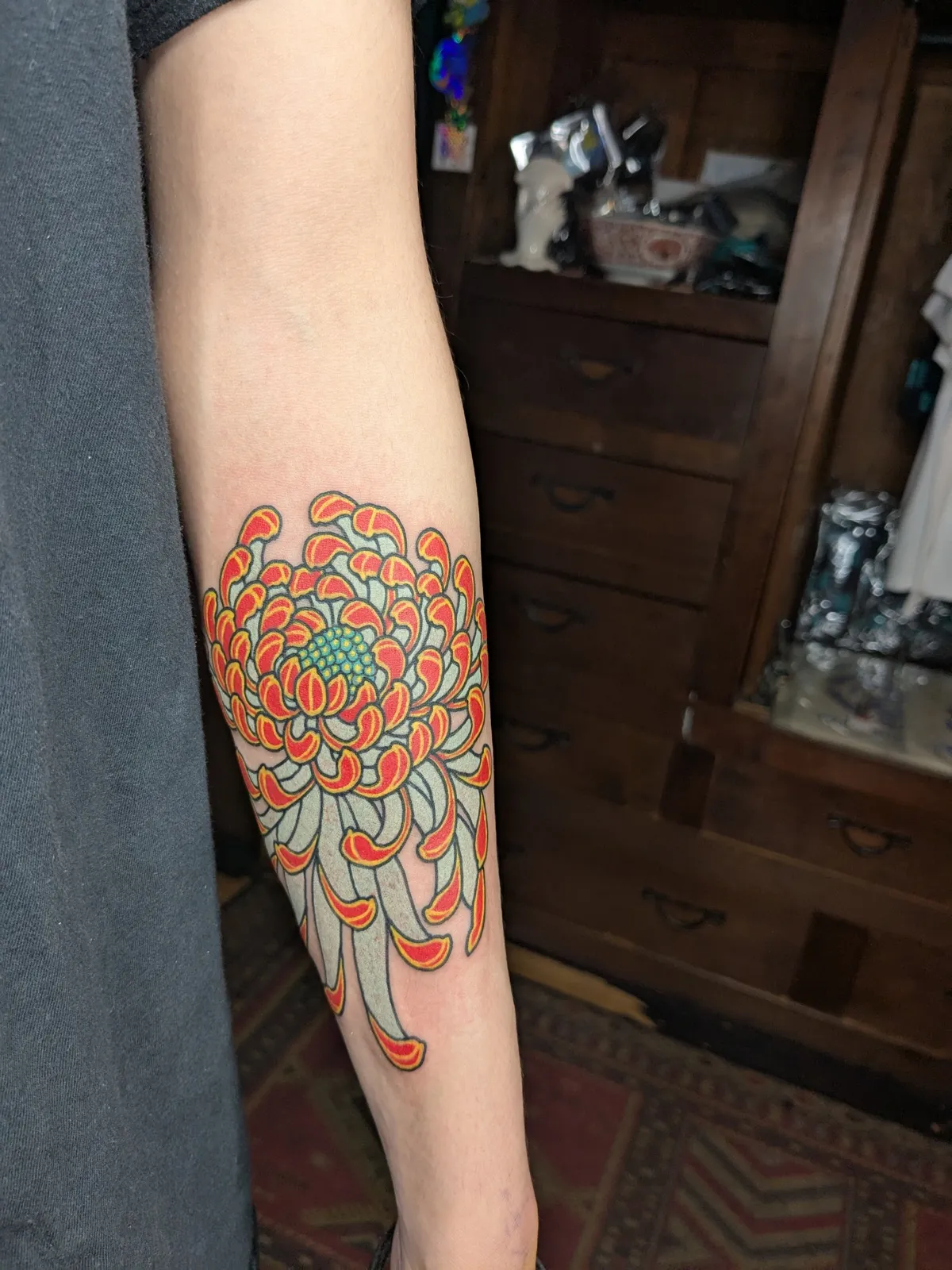 Chrysanthemum tattoo on the forearm
