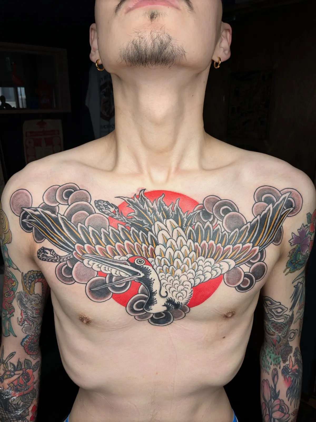 Crane and rising sun tattoo on the chest