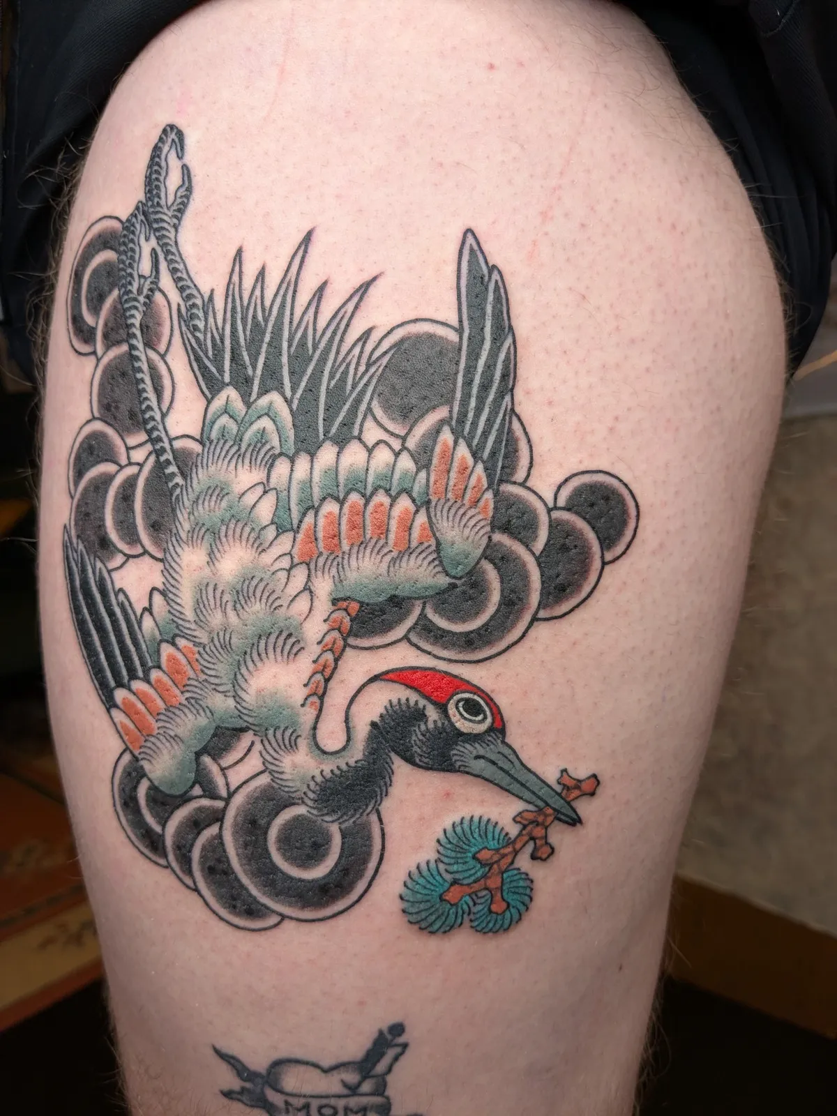 Crane tattoo on the thigh