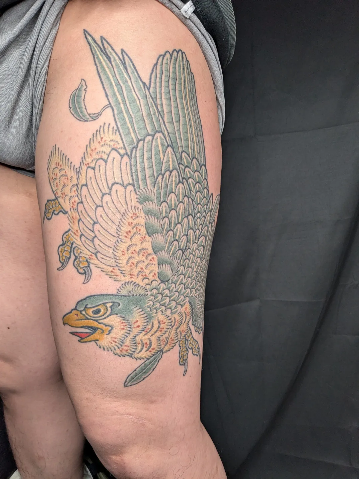 Falcon tattoo on the thigh