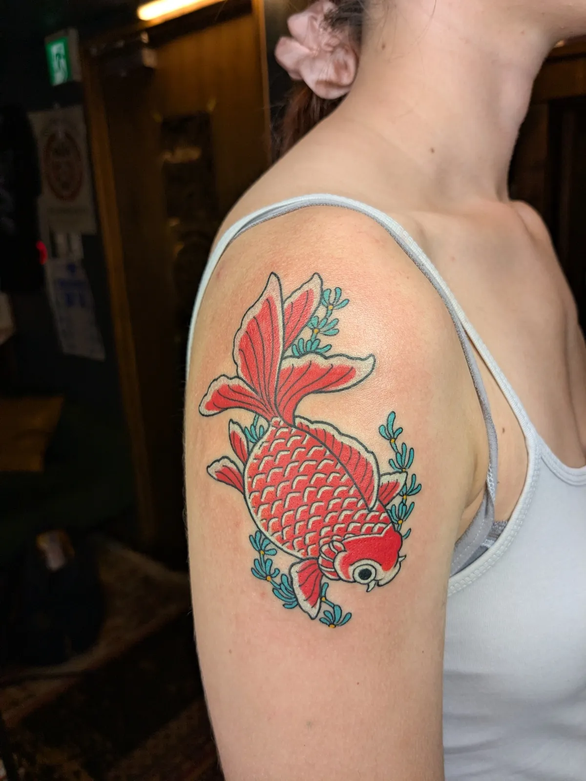 Goldfish tattoo on the upper arm