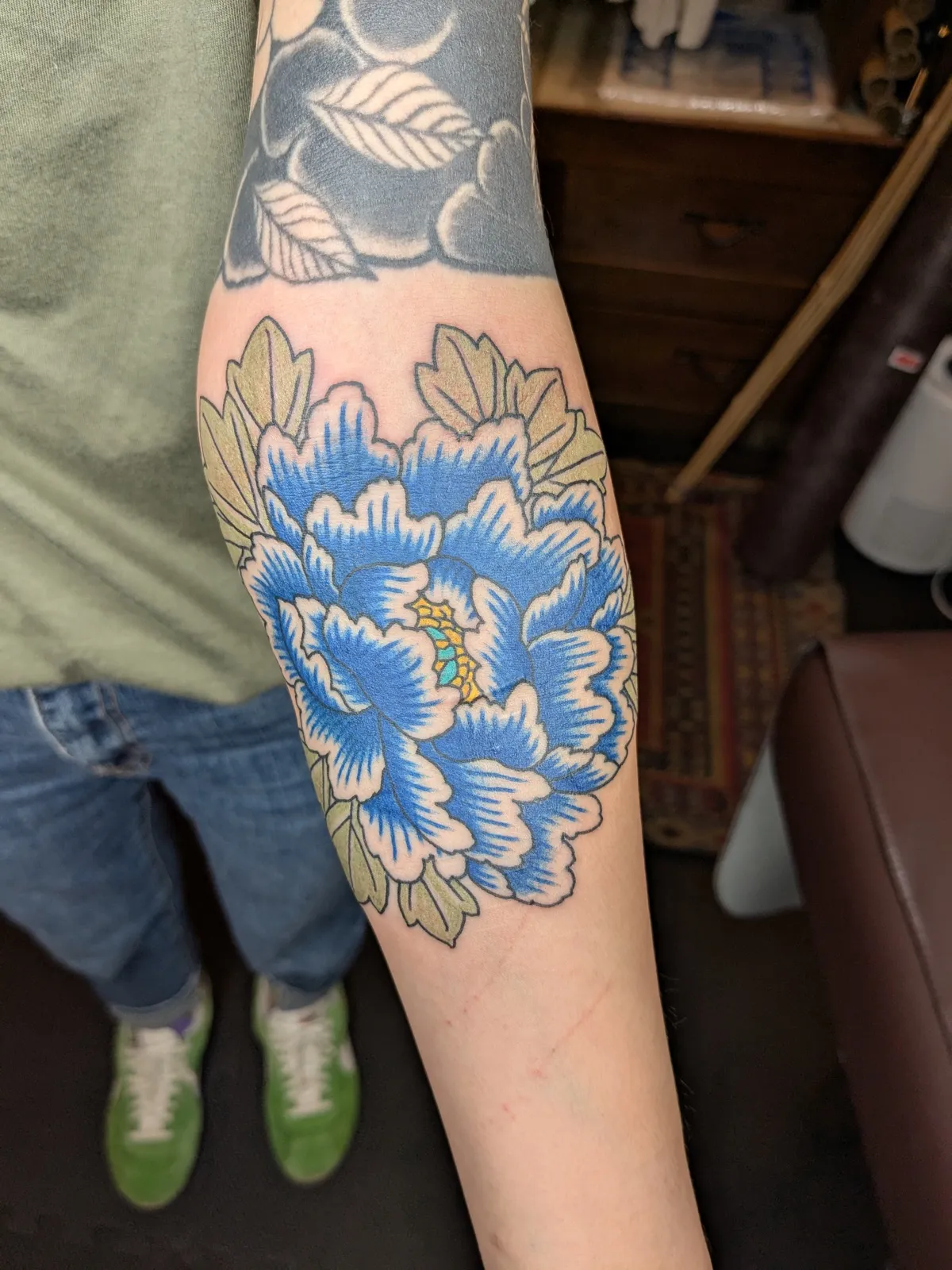 Peony tattoo on the forearm