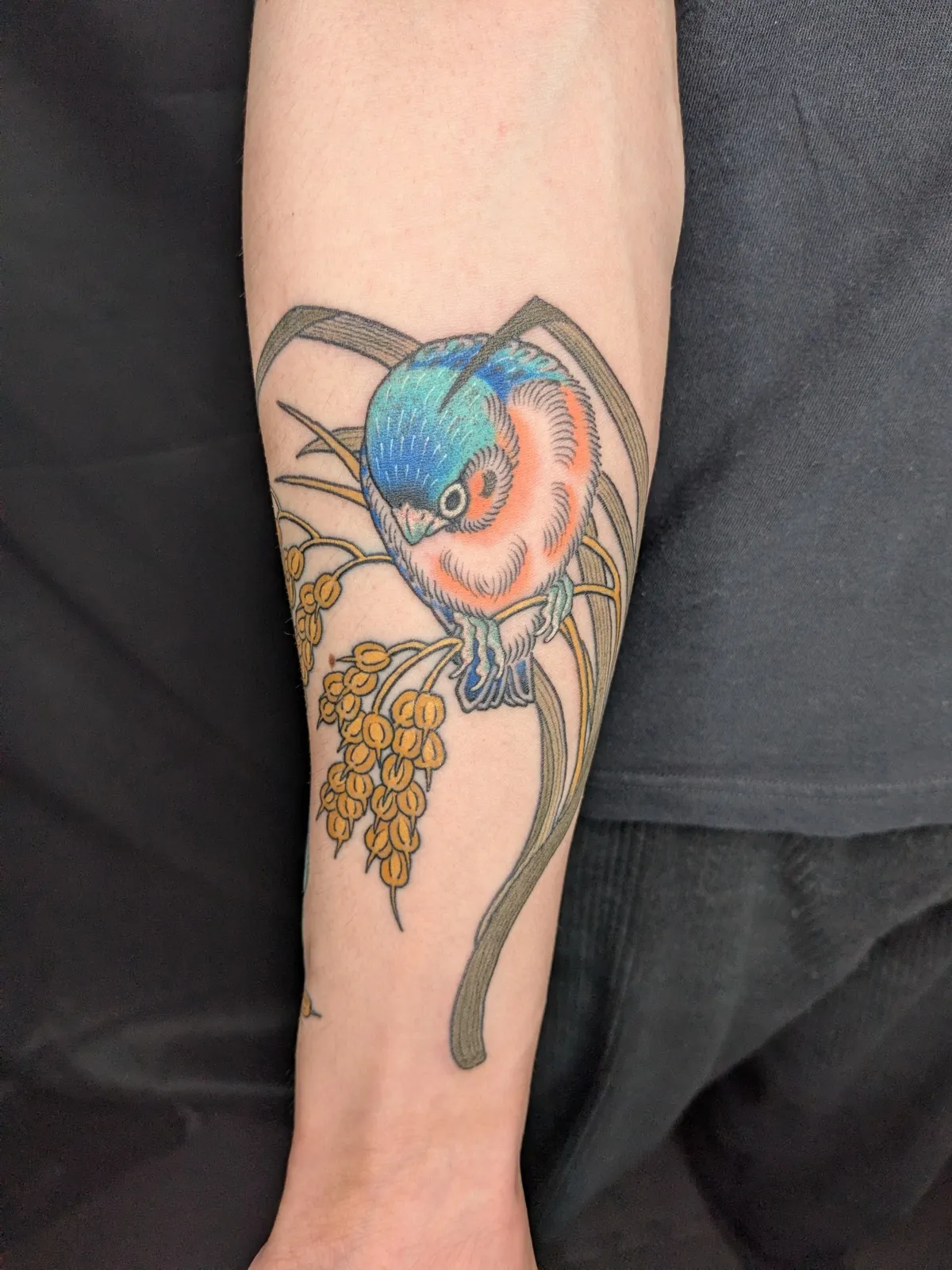 Sparrow and rice tattoo on the forearm