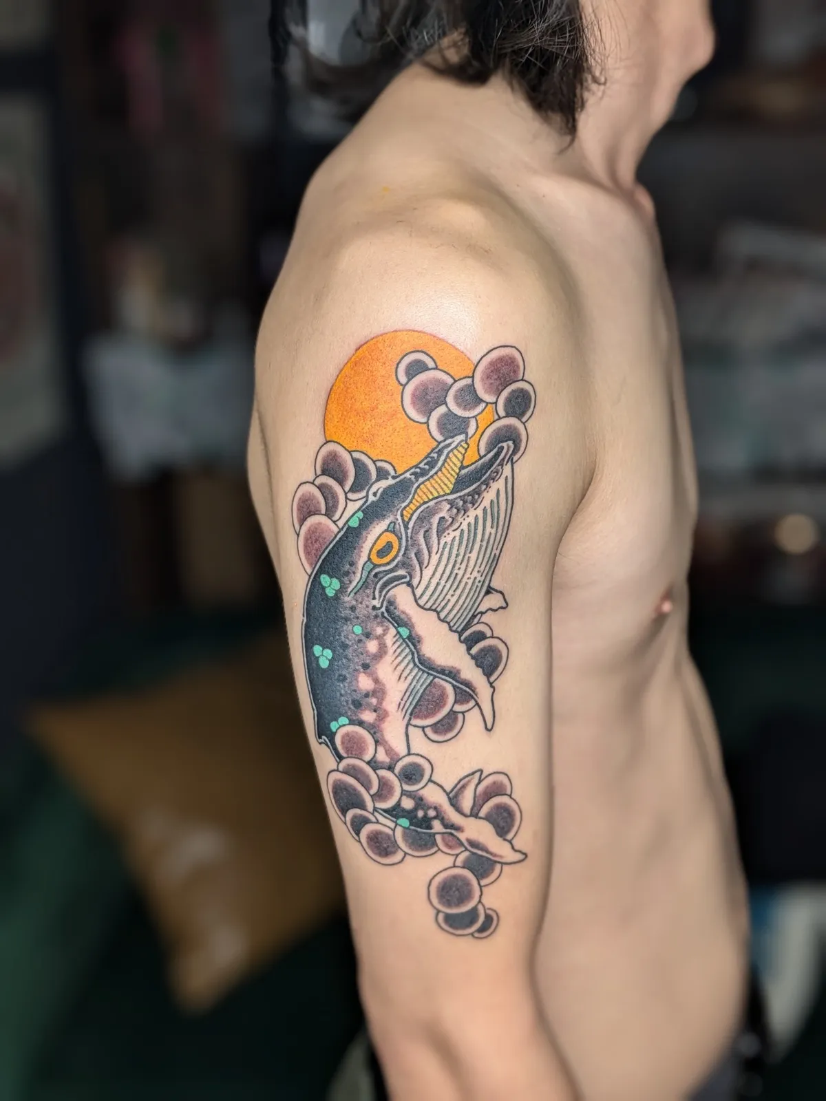 Whale tattoo on the upper arm